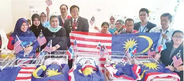  ??  ?? Jainab (left) poses with Malaysia Day babies at the Sabah Women and Children Hospital Likas yesterday.