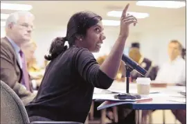  ?? Brandon Dill/special to The Commercial Appeal ?? Nithya Vaduganath­an, a member of the Boston Consulting Group, addresses a recent meeting of the Transition Planning Commission, including Shelby County Mayor Mark Luttrell (left) and Staley Cates.