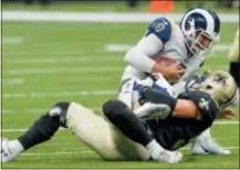  ??  ?? New Orleans Saints linebacker Nate Stupar (54) sacks Los Angeles Rams quarterbac­k Brandon Allen (8) during the first half of a 2018 NFL preseason game in New Orleans, La.