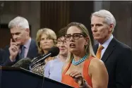  ?? AP PHOTO/J. SCOTT APPLEWHITE ?? Sen. Kyrsten Sinema, D-ariz., center, joined from left by, Sen. Bill Cassidy, R-LA., Sen. Lisa Murkowski, R-alaska, Sen. Susan Collins, R-maine, and Sen. Rob Portman, R-ohio, speak to reporters just after a vote to start work on a nearly $1trillion bipartisan infrastruc­ture package, at the Capitol in Washington, Wednesday, July 28, 2021.