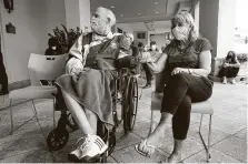  ?? Lynne Sladky / Associated Press ?? Ken Fishman, 81, and EstherWall­ach, 82, wait for the vaccine at The Palace assisted living facility Tuesday in Coral Gables, Fla.