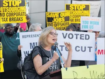  ?? Allen J. Schaben Los Angeles Times ?? REPS. Ed Royce of Fullerton, Mimi Walters of Irvine, Dana Rohrabache­r of Huntington Beach and Darrell Issa of Vista are among Democrats’ top targets. Above, Octavia Toohey at a December rally at Walters’ office.