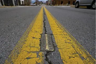  ?? ?? ABOVE
Brass markers, marking the state line Feb. 23 between Bristol, Tenn. and Bristol, Va., line State Street in Bristol, Va. Residents in southweste­rn Virginia have battled for months over whether abortion clinics limited by strict laws in other states should be allowed to hop over the border and operate there. Similar scenarios are beginning to play out in communitie­s along state lines around the country since the U.S. Supreme Court overturned Roe v. Wade. (AP Photo/earl Neikirk)