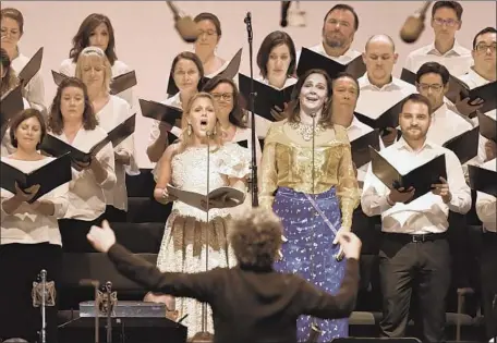  ?? Photograph­s by Myung J. Chun Los Angeles Times ?? VOCAL soloists Miah Persson, center left, and Anna Larsson, center right, and the Master Chorale, led by conductor Gustavo Dudamel.