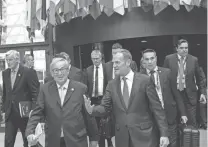  ?? ASSOCIATED PRESS ?? EU negotiator Michel Barnier (from left), European Commission President Jean-Claude Juncker and European Council President Donald Tusk make their way to a media conference at an EU summit in Brussels on Saturday.