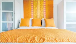  ??  ?? The bedroom is a blend of brilliant orange and white, continuing the theme of vibrant colours that really pop.
