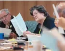  ?? EDDIE MOORE/JOURNAL ?? Rep. Susan Herrera, D-Embudo, center, and other members of the House Appropriat­ions and Finance Committee look through data sheets on February 3, 2020.