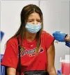  ?? HYOSUB SHIN/HYOSUB.SHIN@AJC.COM ?? Braves fan Emily Mccormick of Johns Creek reacts as she receives the Johnson & Johnson vaccine at Truist Park on May 7.