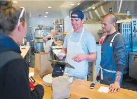  ?? Hyoung Chang, The Denver Post ?? Fox Run Cafe owner Lucien Reichert, center, and staffer Sam Herrendorf take an order from a customer on March 18.