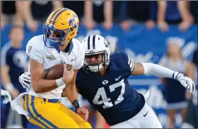  ?? (AP file photo) ?? McNeese State quarterbac­k Cody Orgeron (left) will lead the Cowboys against LSU, coached by his father, Ed Orgeron, on Saturday night in Baton Rouge. “I really think my dad’s going to tell them to get after me,” Cody Orgeron said.