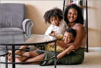  ?? AP PHOTO/MATT YORK ?? Kisha Gulley appears with her sons Sebastian, 2, left, and Santana, 5, Sept. 3 in Phoenix. Gulley is an Instagram influencer and blogger who generates income from her content.