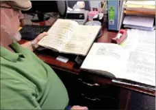  ?? Times photograph by Annette Beard ?? Gateway Mayor David White shows two books found at Gateway Town Hall containing city records from the 1950s, ’60s and ’70s. Some old ledgers were reported missing.