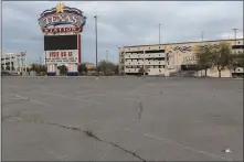  ??  ?? Weeds sprout in the parking lot of the still-closed Texas Station. The resort-casino is approachin­g the one-year anniversar­y of being closed.