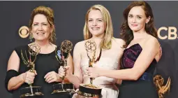  ?? (AP) ?? EMMY WINNERS – Ann Dowd (from left), winner for outstandin­g supporting actress in a drama series, Elisabeth Moss, for outstandin­g lead in a drama series, and Alexis Bledel, for outstandin­g guest actress in a drama for “The Handmaid’s Tale,” pose after...