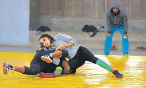  ?? SHARMA/HT PHOTOS ?? Lalita Sehrawat (right) wrestles with a male opponent during a practice session in Hisar ARUN