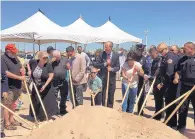  ?? DAN MCKAY/JOURNAL ?? Mayor Richard Berry, center, and Michelle Carlino-Webster, next to him, participat­e in a ceremonial groundbrea­king for a children’s park in Albuquerqu­e. It will be named in honor of Daniel Webster, a police officer killed in the line of duty and the...
