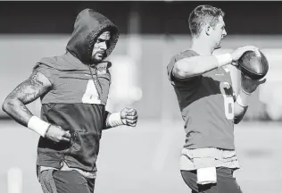  ?? Brett Coomer / Staff photograph­er ?? The Texans’ new policy of having Deshaun Watson, left, work indoors will allow other quarterbac­ks, like Jeff Driskel, to participat­e in practice without any distractio­ns.