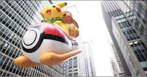  ?? Charles Sykes / Associated Press ?? The Pikachu and Eevee balloon float in the Macy’s Thanksgivi­ng Day Parade on Thursday in New York.