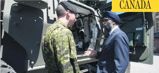  ?? ADRIAN WYLD / THE CANADIAN PRESS ?? Defence Minister Harjit Sajjan meets with Cpl. Kevin Huard in Ottawa Wednesday following the announceme­nt of the Canadian Defence Review. The federal government has pledged more funds for equipment — including 15 new warships and 88 new fighter jets —...