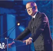  ?? Alberto Rodriguez Getty Images for amfAR ?? TOM HANKS presented the award to Roberts, saying she was devoted to family and charitable pursuits.