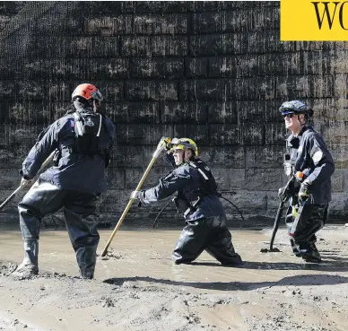  ?? MARCIO JOSE SANCHEZ / THE ASSOCIATED PRESS ?? Fire crews struggle through a “sticky mess” of mud and flooded waters in Montecito, Calif., on Wednesday after mudslides triggered by heavy rain swept away dozens of homes and killed several residents of the wealthy enclave.