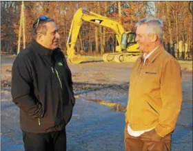  ?? KRISTI GARABRANDT — THE NEWS-HERALD ?? Eastlake Mayor Dennis Morley, left, and Buckeye Relief founder and CEO Andy Rayburn stand at the former JFK property now owned by Rayburn, discussing the plans for the new medical marijuana facility to be built there.