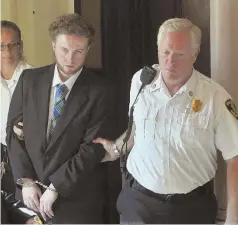  ??  ?? IN COURT: Thomas Latanowich is led into his arraignmen­t in Barnstable Superior Court yesterday on charges including the murder of Yarmouth police Sgt. Sean Gannon, inset.