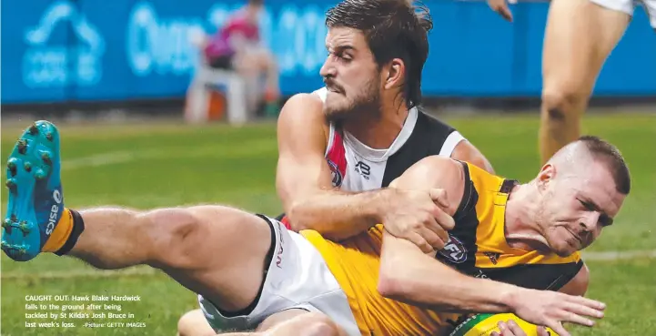  ?? Picture: GETTY IMAGES ?? CAUGHT OUT: Hawk Blake Hardwick falls to the ground after being tackled by St Kilda’s Josh Bruce in last week’s loss.