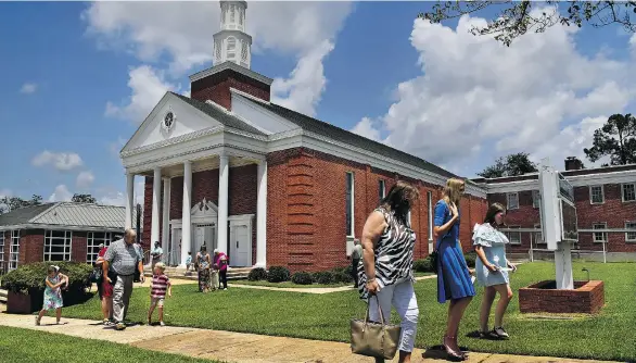  ?? PHOTOS: MICHAEL S. WILLIAMSON/THE WASHINGTON POST ?? Congregant­s leave the First Baptist Church in Luverne, Ala., following Sunday service.