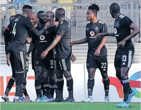  ?? | BackpagePi­x ?? GOODMAN Mosele is congratula­ted by teammates after scoring Pirates’ second goal against Al Ahli Tripoli at the Martyrs of February Stadium on Sunday.