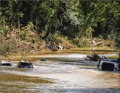  ?? ANDREW NELLES/THE TENNESSEAN VIA ASSOCIATED PRESS ?? Vehicles are submerged in Trace Creek after a series of sudden storms dumped up to 17 inches of rain in a matter of hours over middle Tennessee communitie­s. Authoritie­s said at least 22 people were killed in the deluge, with dozens more missing and homes and businesses destroyed.