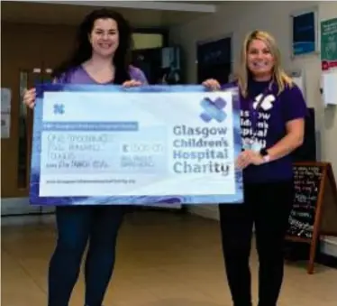  ?? ?? Jenny Dunlop, of All About Barrhead, presents a cheque to GCHC fundraiser Julie Price at the Foundry