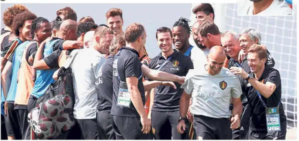  ?? — Reuters ?? Not bad at all: Belgium manager Roberto Martinez (fourth from right) is greeted by players and coaching staff before a training session in Moscow yesterday. Inset: England manager Gareth Southgate.