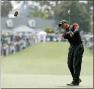  ?? CHARLIE RIEDEL — THE ASSOCIATED PRESS ?? Tiger Woods hits on the first fairway during the fourth round at the Masters golf tournament Sunday in Augusta, Ga.