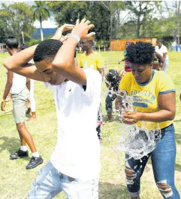  ?? CHIEF PHOTO EDITOR RICARDO MAKYN/ ?? Mackayre Lewis and Matoya Geohagan are heartbroke­n as their water balloon bursts while participat­ing in a relay at the New Covenant Ministries Internatio­nal annual family fun day at the Gray’s Inn Sports Complex in Annotto Bay, St Mary, on Emancipati­on Day. Bishop Richardo Gordon emphasised that it was an opportunit­y to get the youth in the community to participat­e in team-building activities.