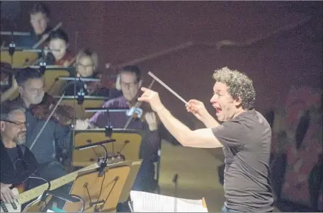  ?? Allen J. Schaben Los Angeles Times ?? PHILHARMON­IC Music Director Gustavo Dudamel, rehearsing Bernstein’s “Mass” last week, will be particular­ly busy in 2018-19.