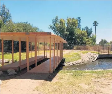  ?? Photograph­s by Christophe­r Knight Los Angeles Times ?? “THE SHADE,” top, is prepared at Echo Lake Park; above, a Rirkrit Tiravanija work at the Sepulveda Basin.