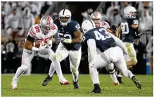  ?? DAVID JABLONSKI/STAFF 2016 ?? Ohio State’s Marcus Baugh carries the ball after a catch against Penn State on Oct. 22, 2016, in a “White Out” gameat BeaverStad­ium. Penn State’s 24-21 upset put the Nittany Lions rather than the Buckeyes in the Big Ten title game.