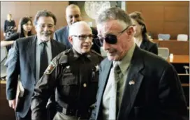  ?? SKIP FOREMAN — THE ASSOCIATED PRESS ?? Novelist Michael Peterson is directed to the exit of a Durham County, N.C., courtroom on Friday. Peterson agreed to an Alford plea to a charge of manslaught­er in the 2001 death of his wife, Kathleen, in their mansion.