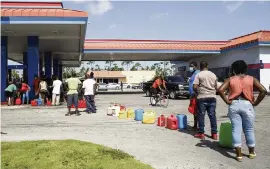  ?? TIM AYLEN AP ?? Residents wait in line to fill as many containers as they can with gasoline before the arrival of Hurricane Isaias in Freeport, Grand Bahama, Bahamas, on Friday.