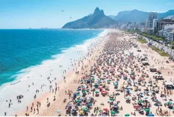  ?? BUDA MENDES/GETTY ?? Beach day: People enjoy a summer day Sunday at Ipanema Beach in Rio de Janeiro. Brazil’s beaches are crowded despite the spread of the omicron variant. The city is still planning a New Year’s Eve party at Copacabana Beach. Brazil has logged over 22.2 million infections and more than 618,000 deaths from COVID-19, according to Johns Hopkins University.