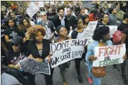  ?? WIN MCNAMEE/ GETTY IMAGES ?? Baltimore college and high school students march in protest Wednesday, chanting “Justice for Freddie Gray” while on their way to City Hall in Baltimore.