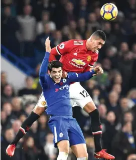  ??  ?? Chris Smalling towers above Chelsea striker Alvaro Morata to head the ball out of danger during Manchester United’s 0-1 loss to Chelsea at Stamford Bridge on Sunday