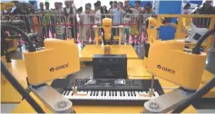  ?? — AFP photo ?? Photo shows robot arms playing music at the 2018 World Robot Conference in Beijing. Robots that can diagnose diseases, play badminton and wow audiences with their musical skills are among the machines China hopes could revolution­ise its economy, with visitors to a Beijing exhibition offered a glimpse of an automated future.