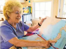  ?? RON DEVLIN/AP ?? Judy Reitz, of Douglassvi­lle, points to Fukushima Prefecture in Japan, home of Toshie Nagasawa, the grandson of a soldier whose diary Reitz’s father found on the Pacific island of Tinian while serving with the Navy Seabees in World War II.