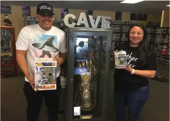  ?? Matt Fernandez/The Signal ?? Andrew and Rocio Aquino, owners of toy and collectibl­e store Pop Cave, display some of their Funko Pop! figurines on sale at their store on Railroad Avenue in Newhall.