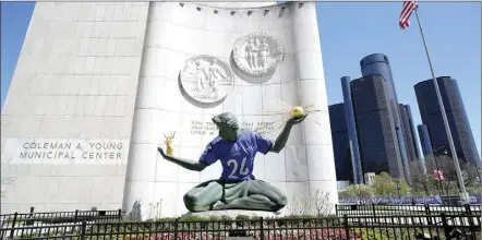  ?? AP photo ?? An NFL football draft jersey is displayed on the Spirit of Detroit statue in Detroit.