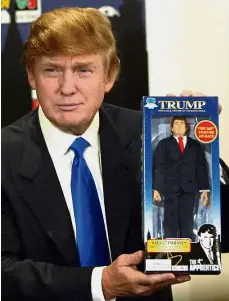  ??  ?? Me and mini me: Trump posing with a talking doll of himself at a toy store in New York in September 2004. — AFP