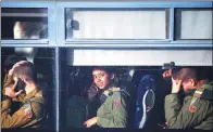  ?? RONEN ZVULUN / REUTERS ?? Israeli soldiers sit in a bus as they leave the scene of a truck-ramming incident in Jerusalem on Sunday.