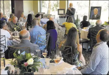  ?? K.M. Cannon Las Vegas Review-Journal @KMCannonPh­oto ?? Matthew Hinueber, brother of Review-Journal attorney Mark Hinueber, speaks Saturday during a memorial for the First Amendment advocate at TPC Summerlin.